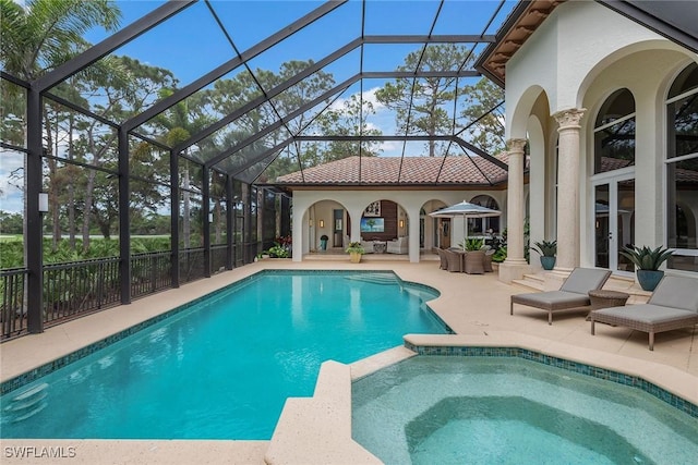 view of pool featuring glass enclosure, outdoor lounge area, a pool with connected hot tub, french doors, and a patio area