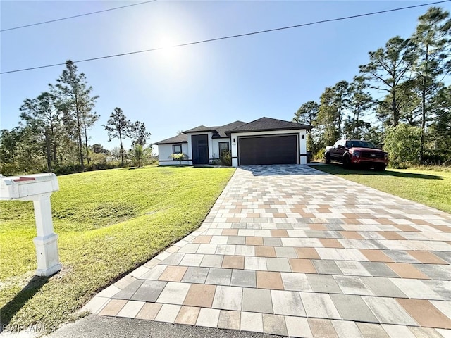 prairie-style home featuring a garage, a front lawn, and decorative driveway