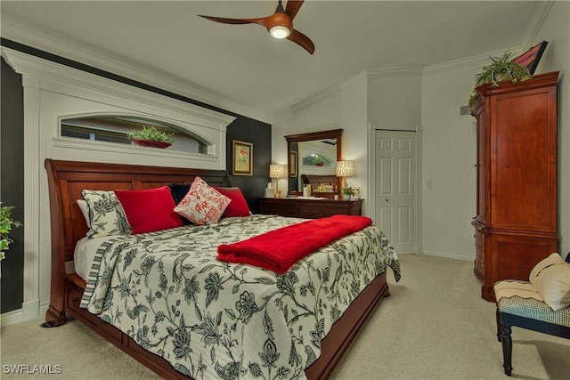 carpeted bedroom featuring baseboards, a ceiling fan, vaulted ceiling, and crown molding