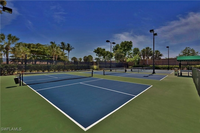 view of sport court featuring fence