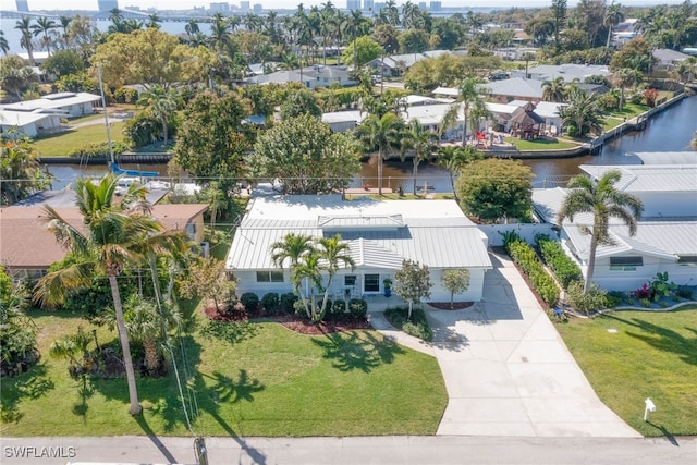 birds eye view of property featuring a water view and a residential view