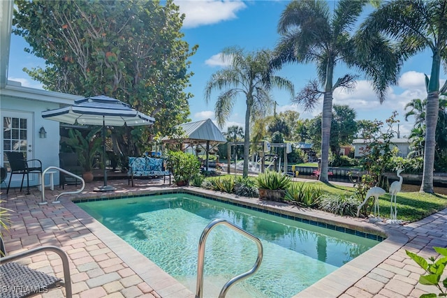 pool with a patio and a gazebo