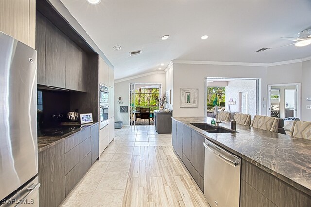 kitchen with visible vents, modern cabinets, appliances with stainless steel finishes, crown molding, and a sink