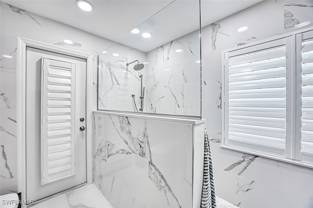 bathroom featuring marble finish floor, a marble finish shower, and recessed lighting