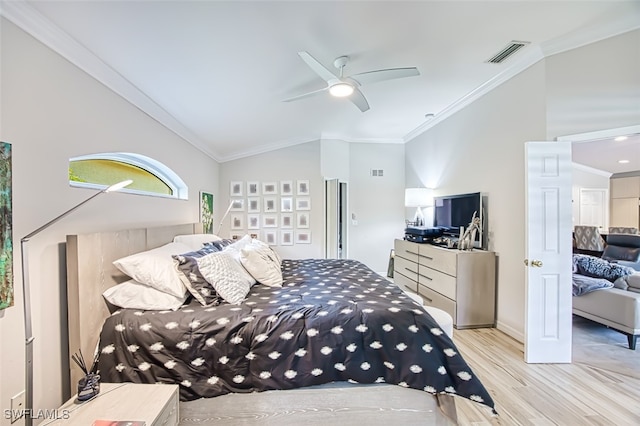 bedroom featuring visible vents, vaulted ceiling, crown molding, and wood finished floors