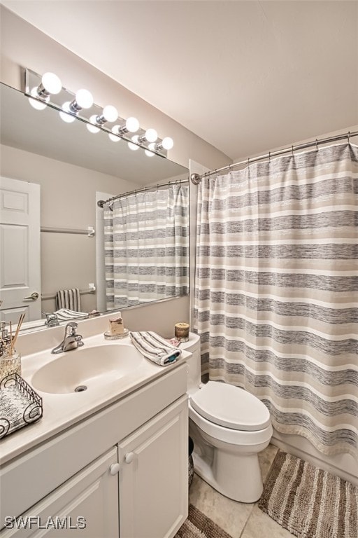 full bath featuring a shower with curtain, vanity, toilet, and tile patterned floors