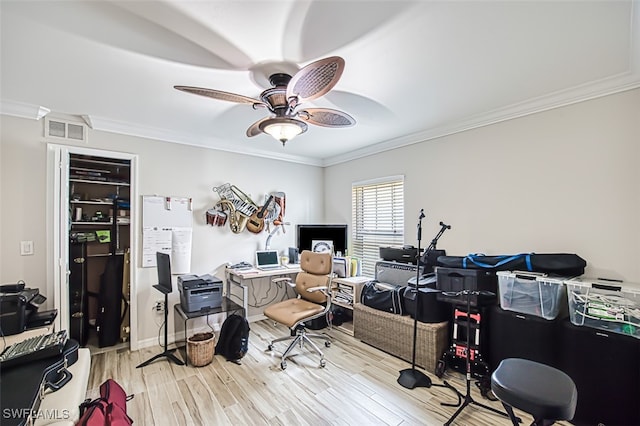 office area with ornamental molding, wood finished floors, visible vents, and a ceiling fan