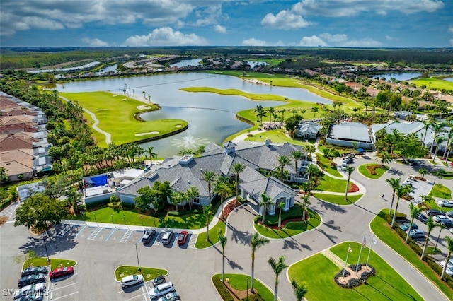 birds eye view of property featuring view of golf course, a water view, and a residential view