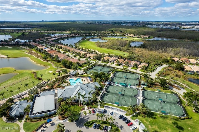 drone / aerial view with golf course view, a water view, and a residential view