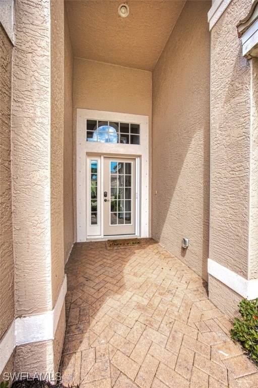 property entrance with stucco siding