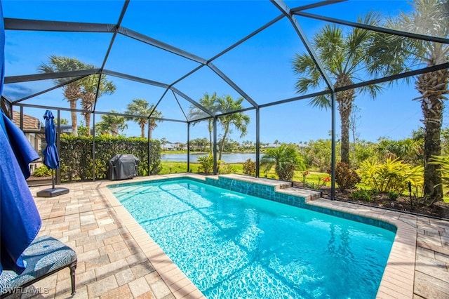 outdoor pool featuring a lanai, a water view, a patio, and grilling area