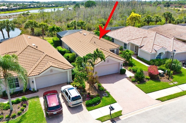 birds eye view of property with a water view