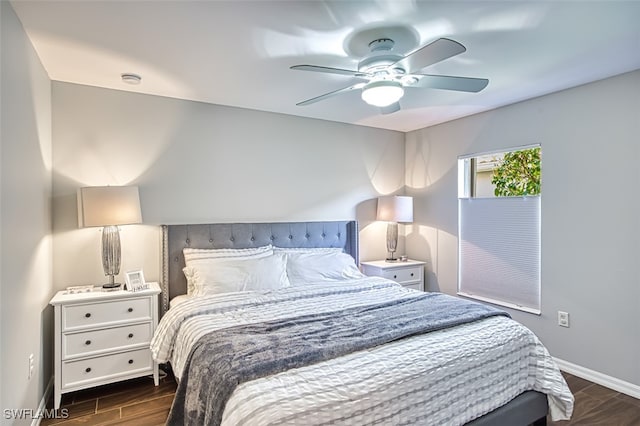 bedroom featuring wood finish floors, a ceiling fan, and baseboards