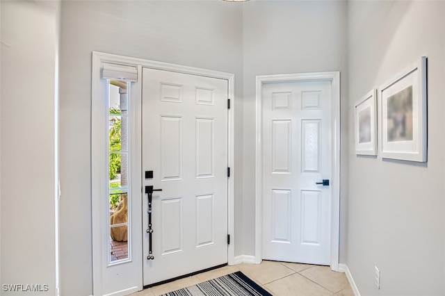 entryway featuring light tile patterned floors and baseboards