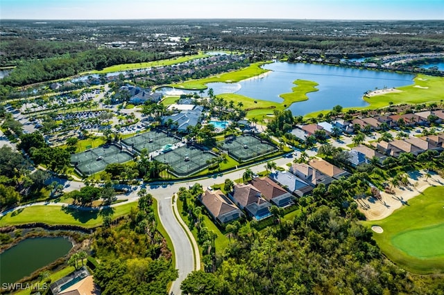 drone / aerial view featuring golf course view, a water view, and a residential view