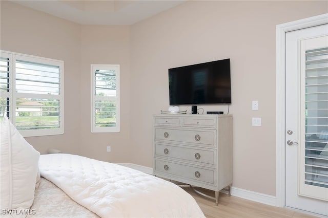 bedroom featuring light wood-style flooring and baseboards