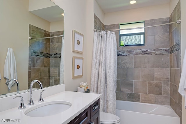 bathroom with toilet, shower / bath combination with curtain, and vanity