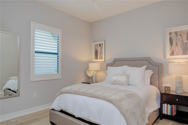 bedroom with light wood-style floors and baseboards