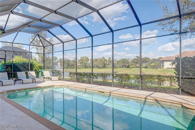 pool with glass enclosure and a patio