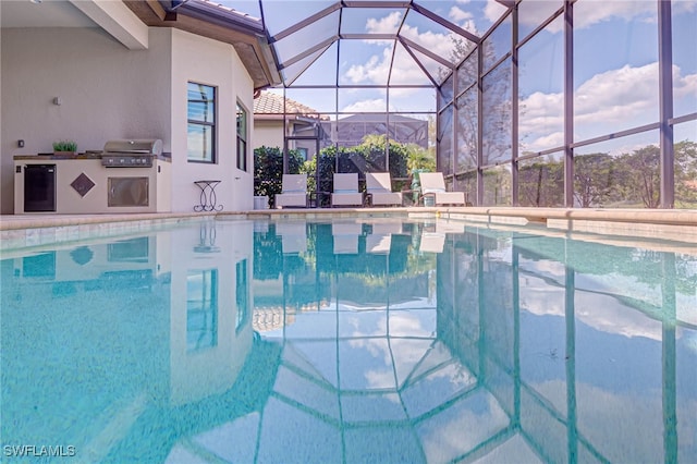 pool with a lanai, grilling area, an outdoor kitchen, and a patio