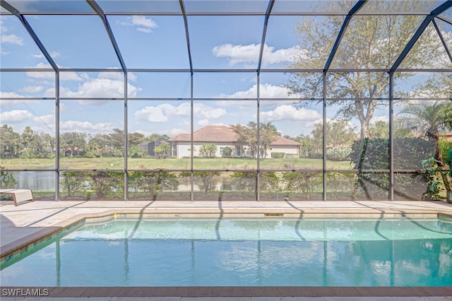 pool featuring a lanai, a water view, and a patio