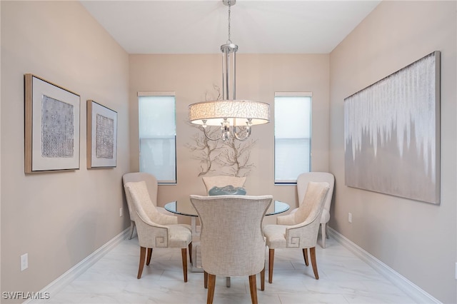 dining room featuring marble finish floor and baseboards