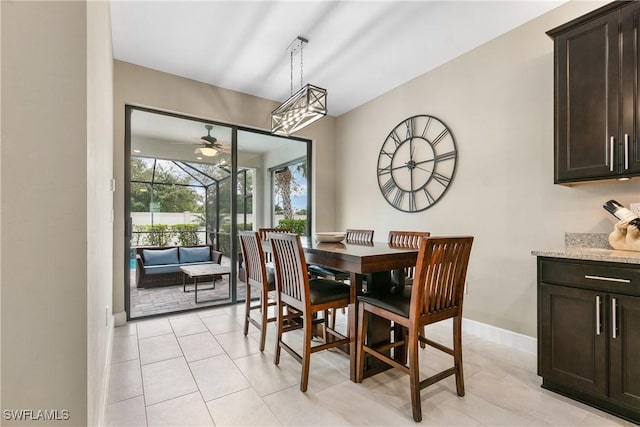 dining room featuring light tile patterned flooring and baseboards