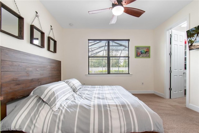 carpeted bedroom featuring a ceiling fan and baseboards