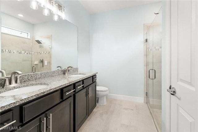 bathroom with double vanity, a stall shower, and a sink