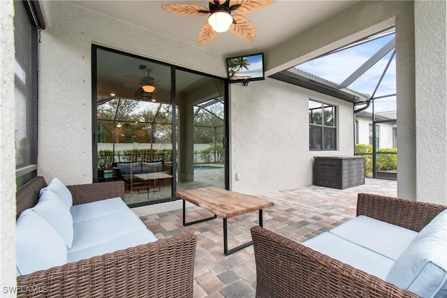 sunroom featuring ceiling fan