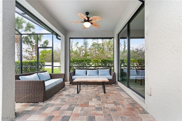 sunroom / solarium with a ceiling fan and a wealth of natural light