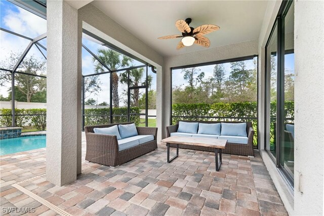 sunroom / solarium featuring a ceiling fan