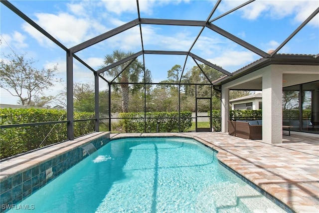 pool with glass enclosure, a patio area, and outdoor lounge area