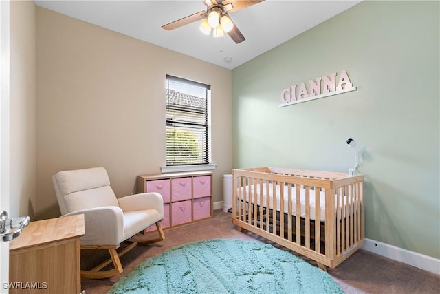 bedroom with baseboards, lofted ceiling, ceiling fan, carpet flooring, and a nursery area