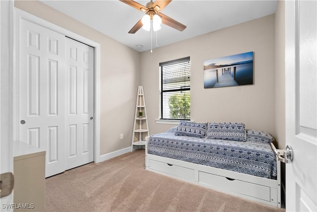 carpeted bedroom featuring ceiling fan, baseboards, and a closet