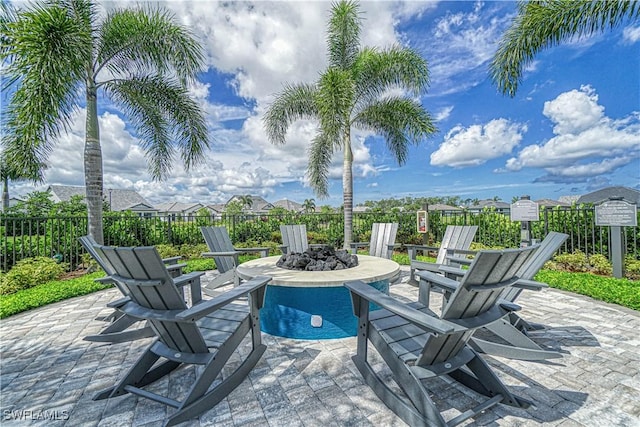 view of patio / terrace with fence and a fire pit