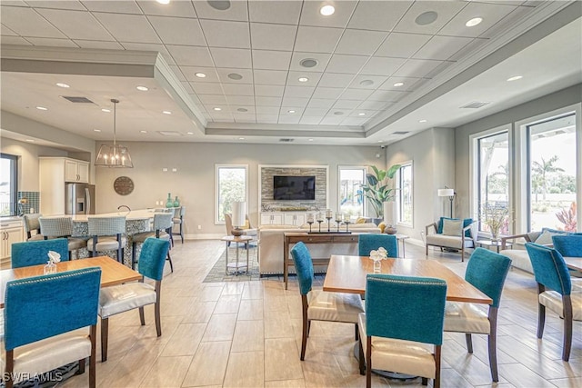 dining space with a tray ceiling, visible vents, baseboards, and recessed lighting