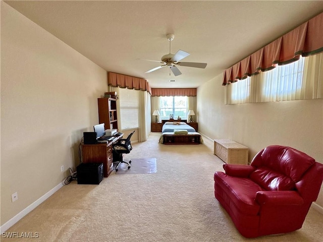 carpeted bedroom featuring ceiling fan and baseboards