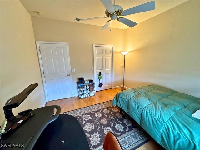 bedroom featuring a ceiling fan and wood finished floors