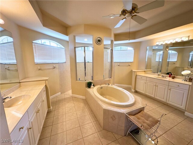 bathroom featuring a walk in shower, plenty of natural light, a sink, and a bath