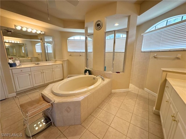 bathroom featuring a garden tub, ceiling fan, a walk in shower, and tile patterned flooring