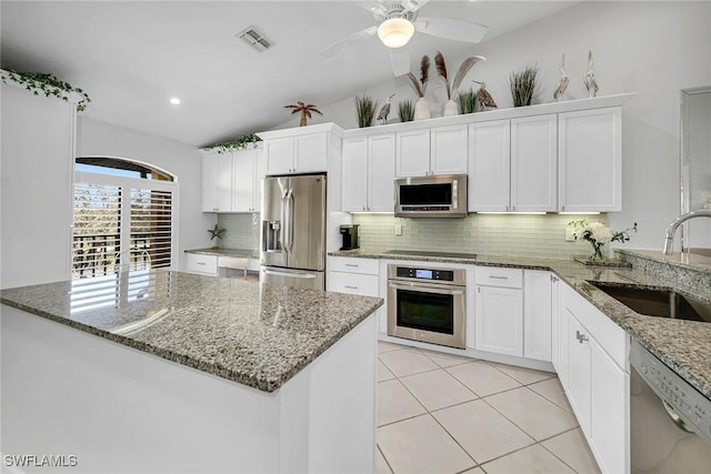 kitchen with light tile patterned floors, visible vents, appliances with stainless steel finishes, white cabinetry, and a sink