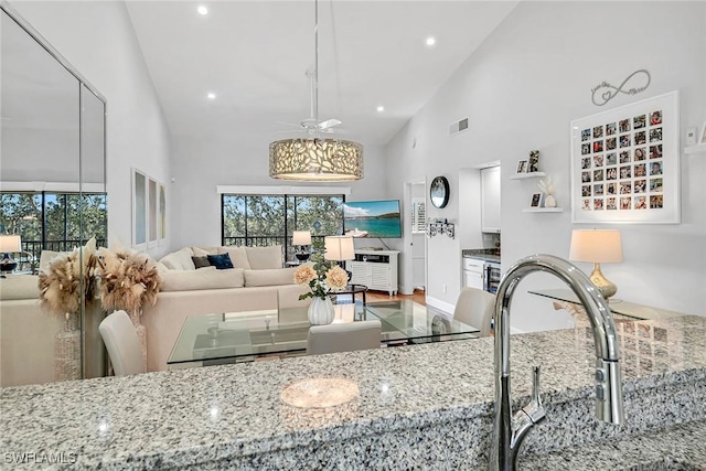 living room featuring wine cooler, recessed lighting, visible vents, a ceiling fan, and high vaulted ceiling