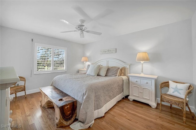 bedroom with light wood-style floors, baseboards, and a ceiling fan