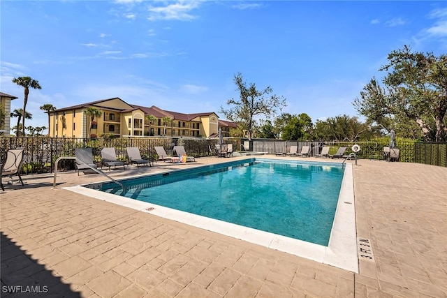 community pool featuring a patio area and fence