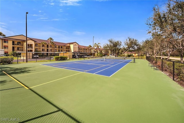 view of tennis court featuring fence