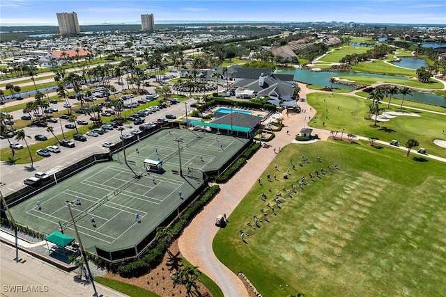 birds eye view of property with golf course view and a water view