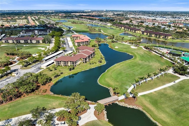 birds eye view of property featuring view of golf course and a water view