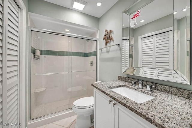 bathroom featuring toilet, recessed lighting, vanity, tile patterned floors, and a stall shower