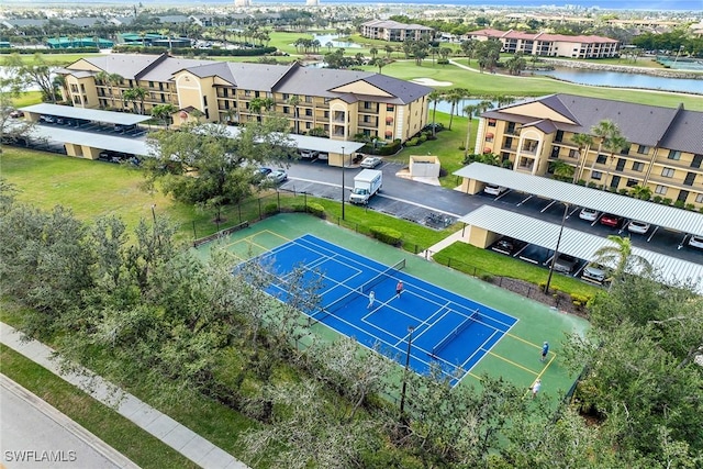 drone / aerial view featuring a residential view and a water view